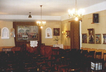 The chamber with the exhibited paintings on the walls.